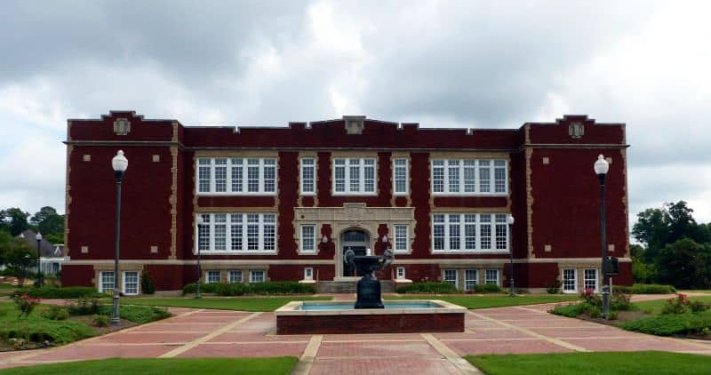 Historic building in Andalusia, Alabama near landscaped grounds representing local land surveying services